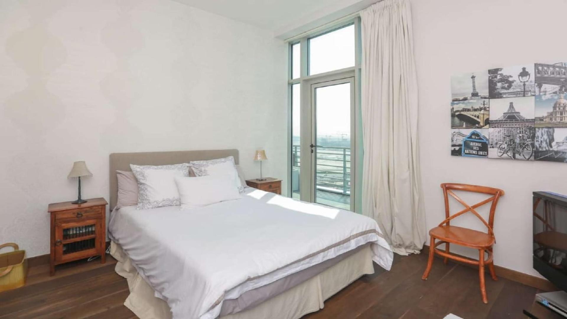 Living room view from upgraded penthouse near Dubai Canal, featuring city skyline