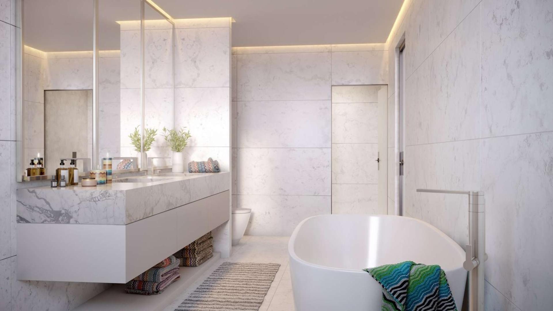 Luxury penthouse dining area with Dubai Canal view, modern decor, and large windows