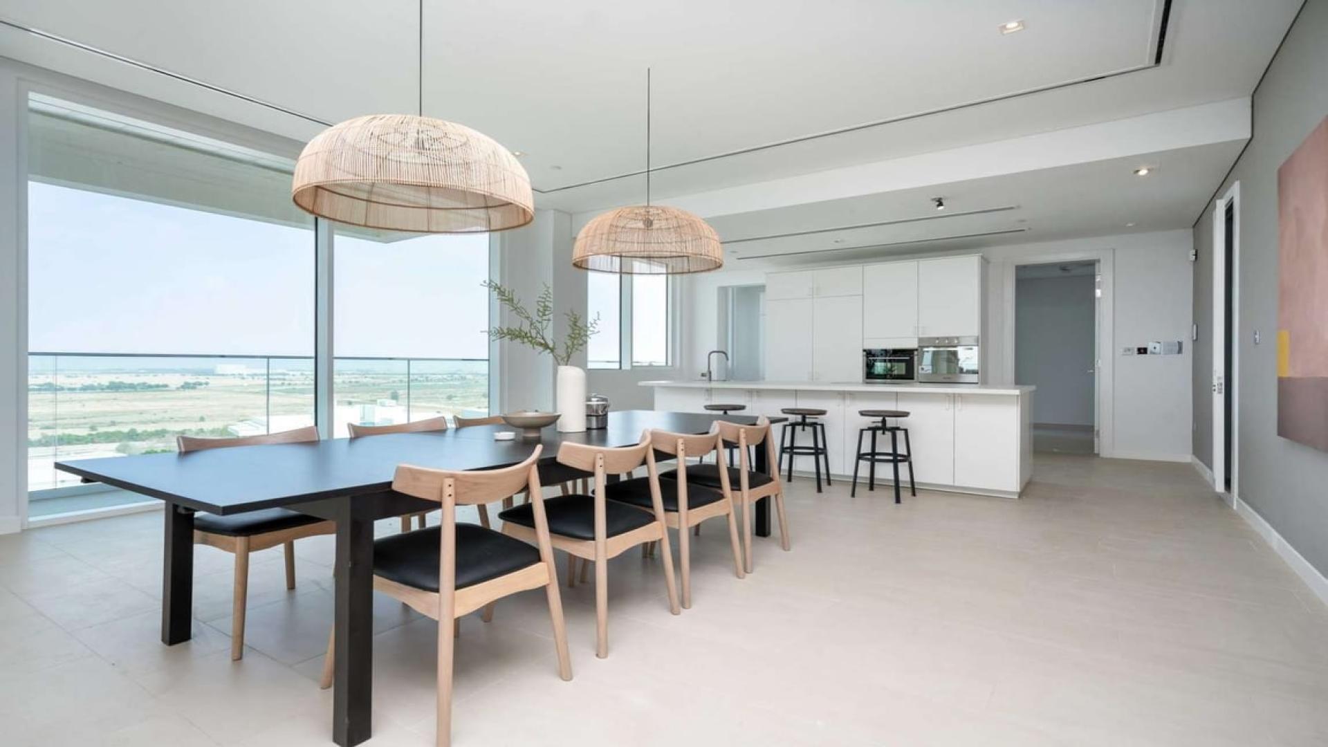 Modern open-plan living area in luxury Al Barari penthouse for rent, featuring elegant decor