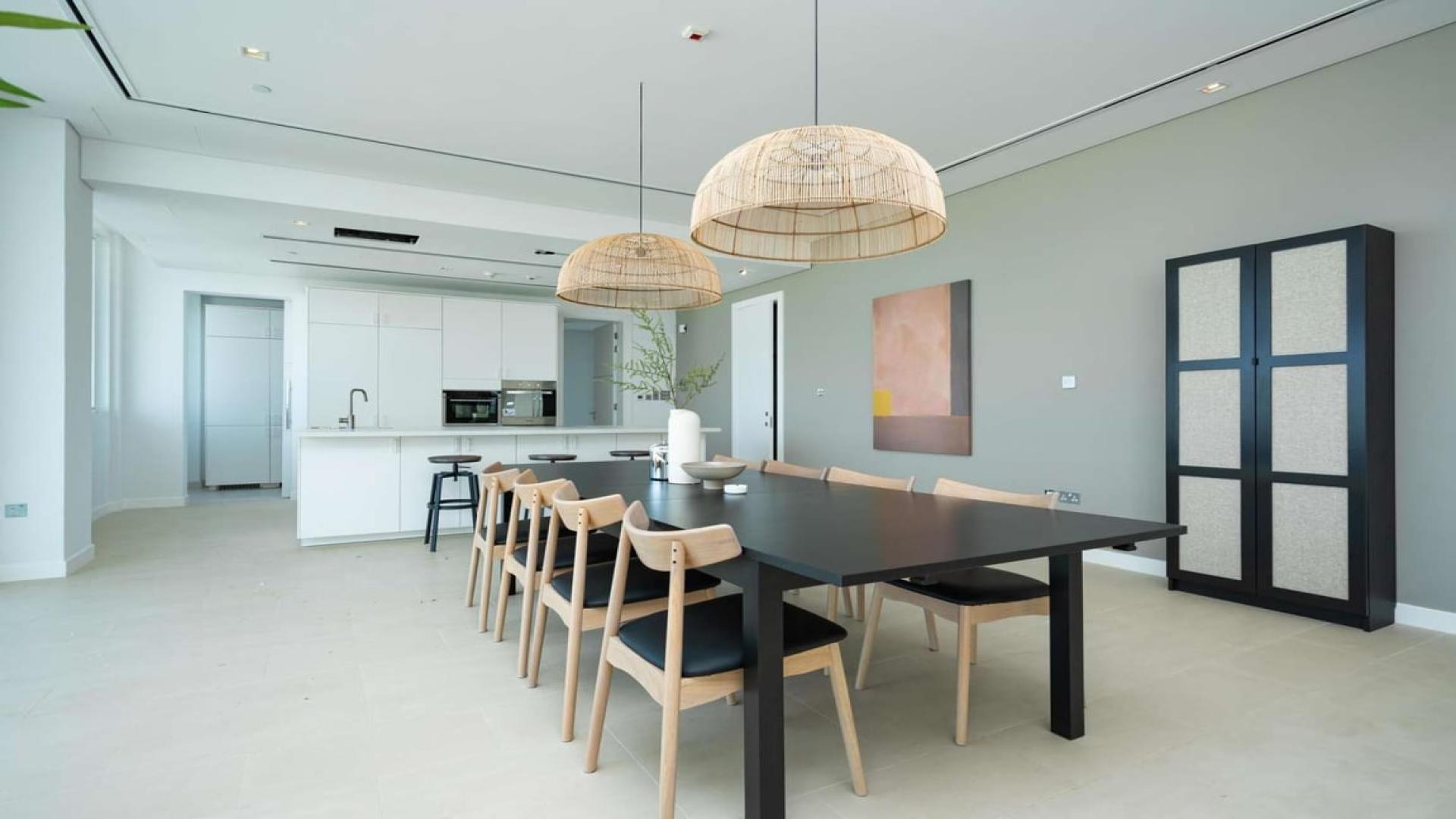 Luxury living room in 3-bedroom Al Barari penthouse with modern decor and panoramic views