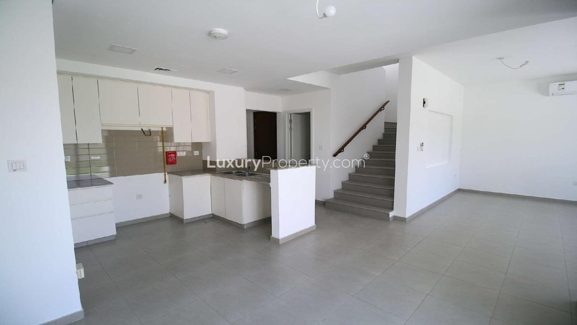 Modern kitchen and staircase in 3-bedroom Zahra Townhouse, Town Square, available for rent
