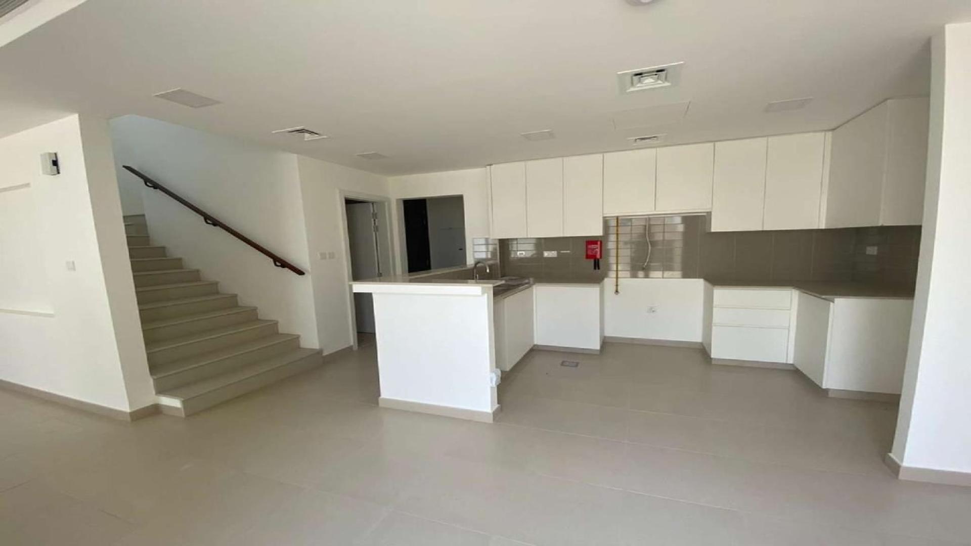Modern kitchen and living area in 3-bedroom townhouse, Noor Town Square, available for rent