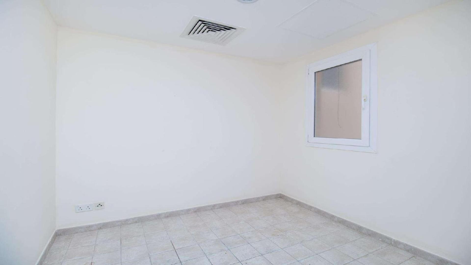 Spacious townhouse exterior with garden in Green Community East, available for rent