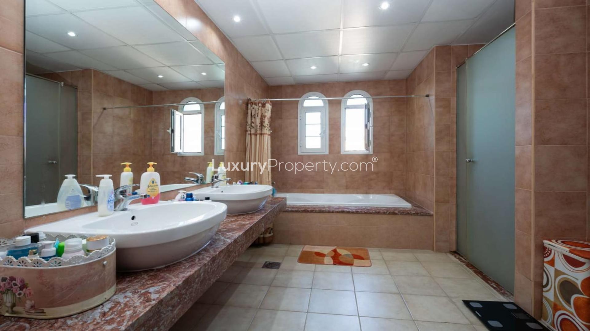 Elegant living room in Jumeirah Village Triangle townhouse, featuring ornate sofas and chandelier