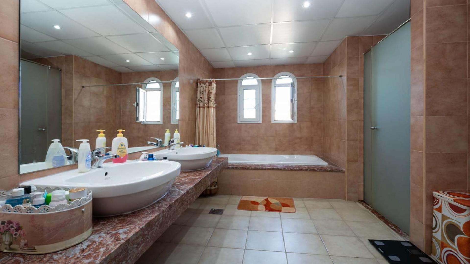 Elegant living room in Jumeirah Village Triangle townhouse, featuring ornate sofas and chandelier