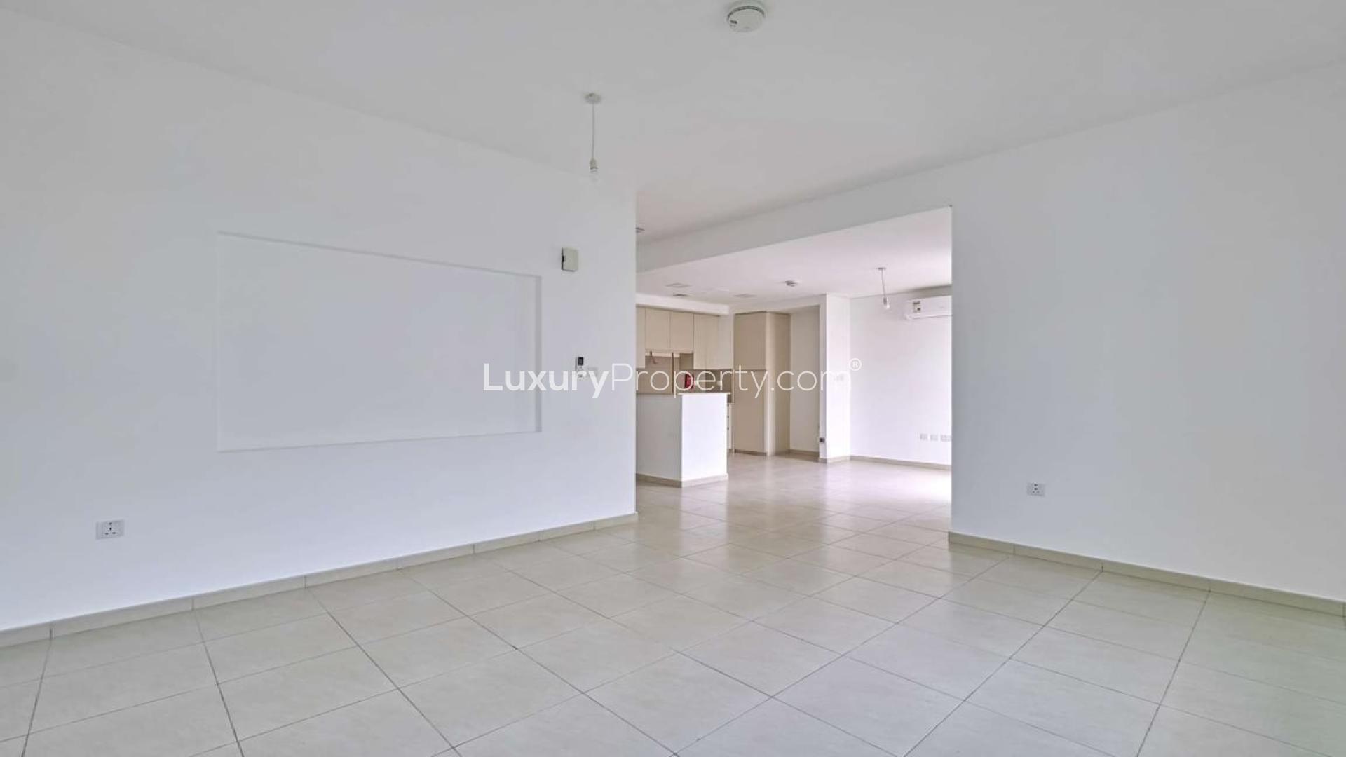 Modern kitchen and living area in Zahra Townhouses, Town Square, for rent