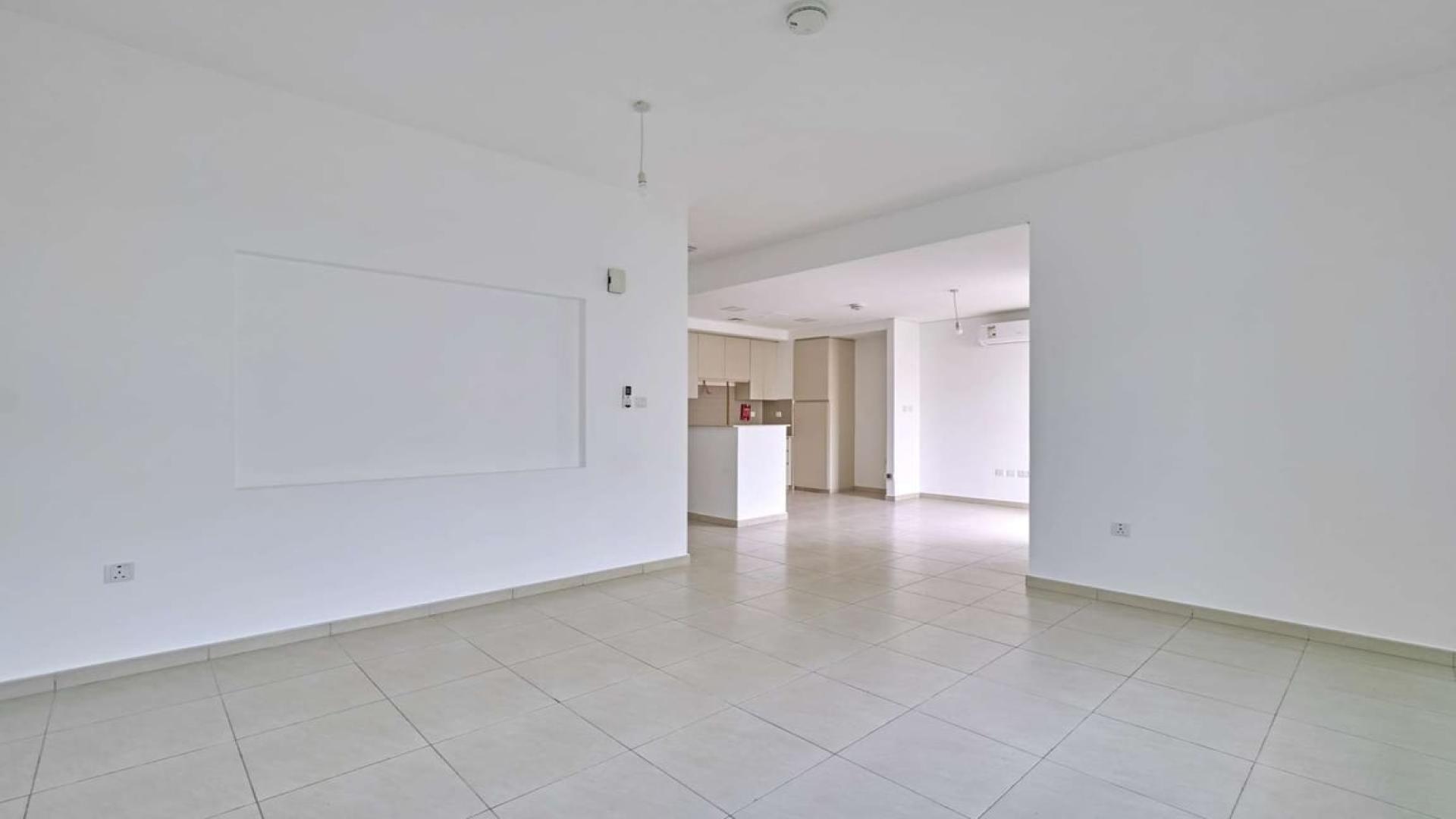 Modern kitchen and living area in Zahra Townhouses, Town Square, for rent