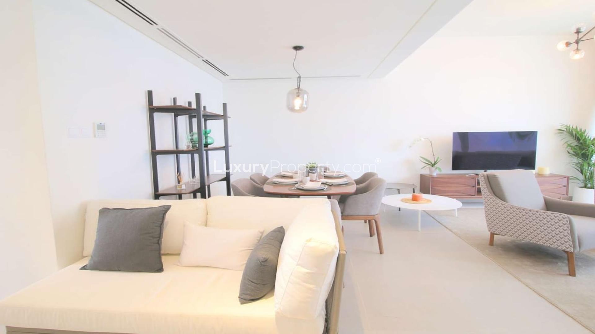 Modern townhouse exterior with white facade and parking area in Arabella 1, Mudon