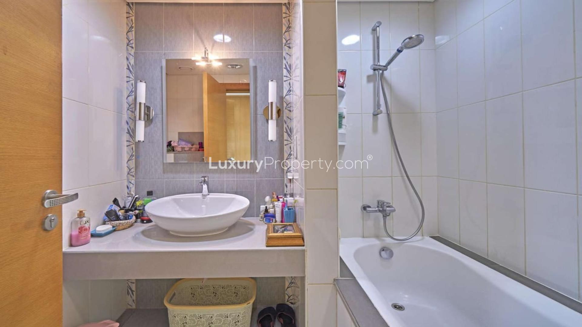 Modern kitchen in Quortaj-style townhouse, Al Furjan North Village, with island and bar stools