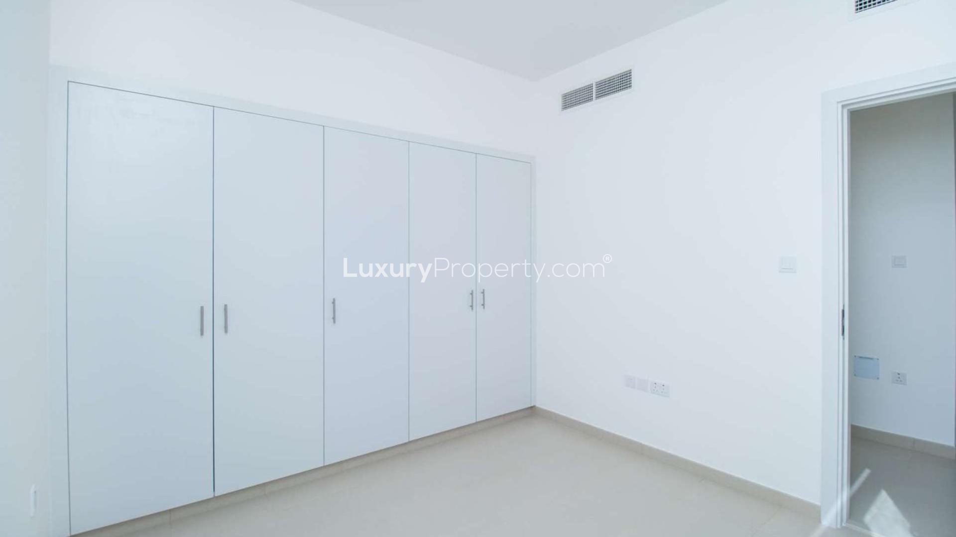 Town Square Noor Townhouses pathway view, landscaped greenery, modern residential architecture