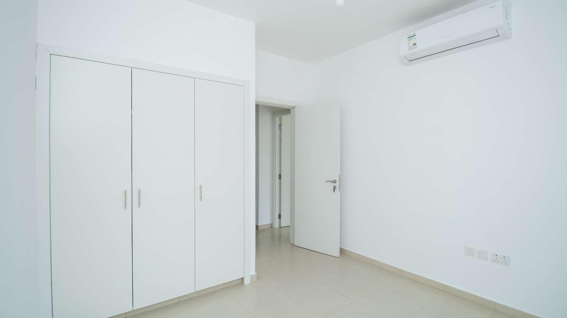 Modern living room with glass doors and staircase in Hayat Townhouse, Town Square