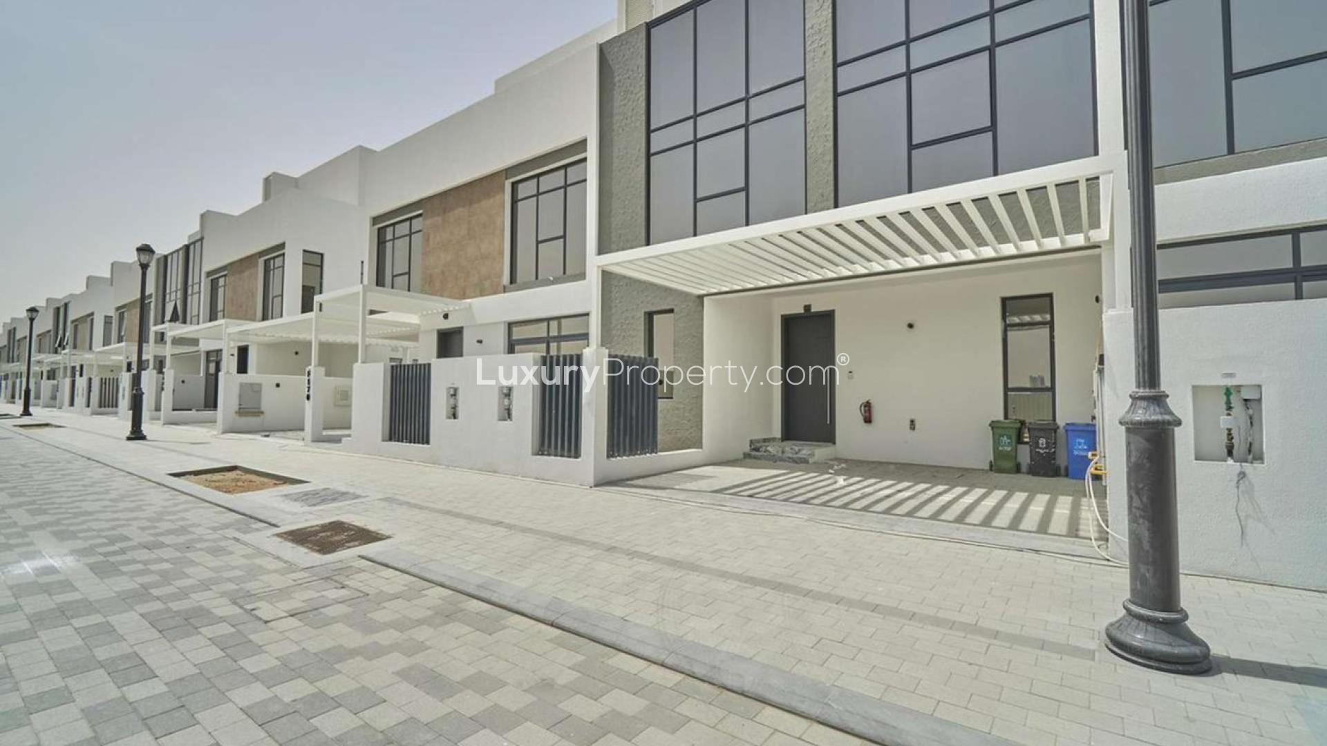 Modern three-bedroom townhouse exterior in Jumeirah Golf Estates, available for rent