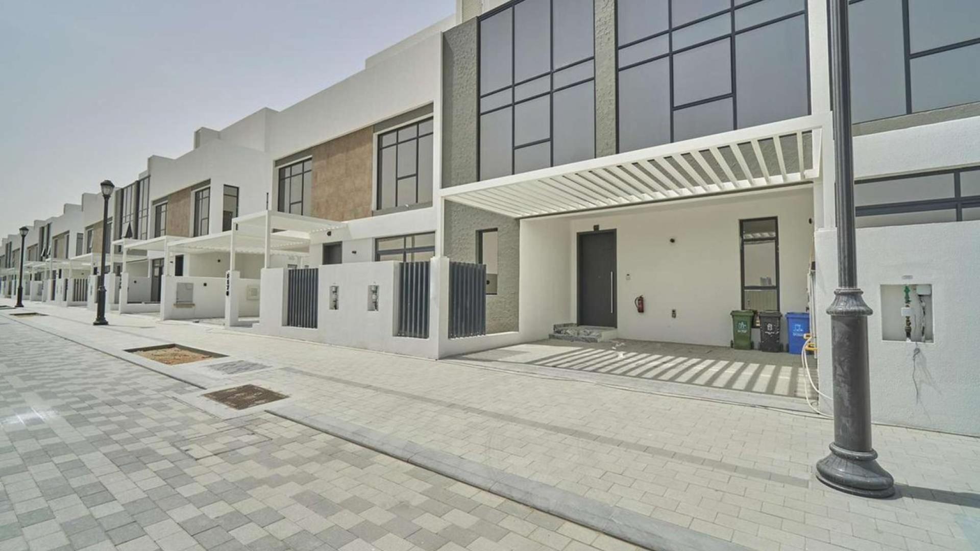 Modern three-bedroom townhouse exterior in Jumeirah Golf Estates, available for rent