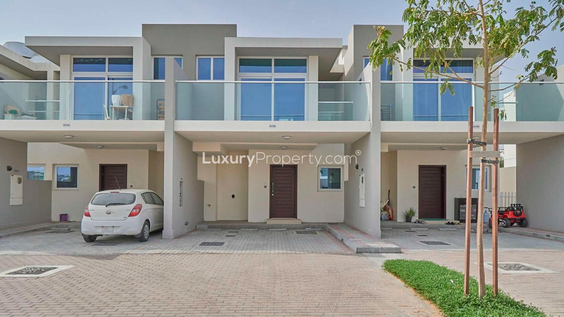 Townhouse exterior view in Albizia, Damac Hills 2, featuring modern architecture and private gardens