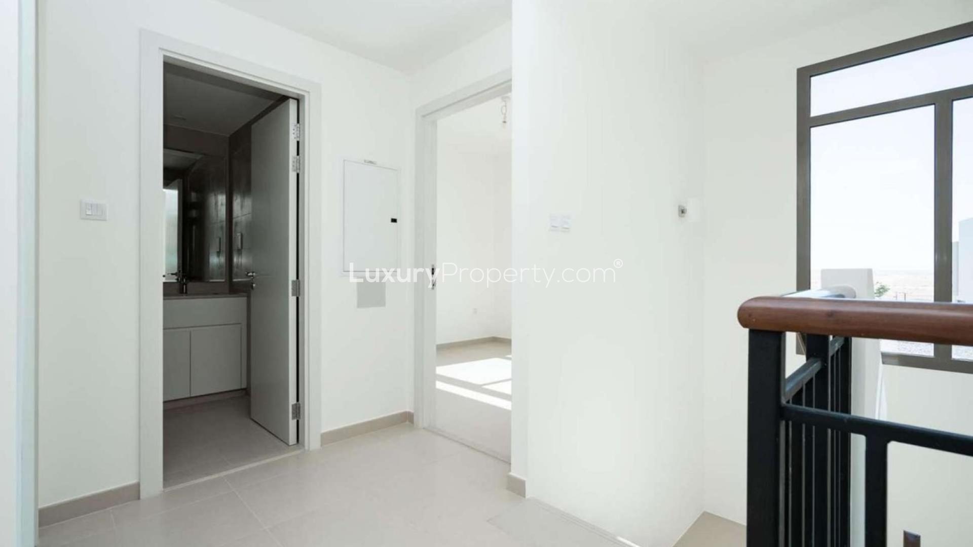 Modern open-plan living area in Hayat Townhouse, Town Square. Spacious with natural light