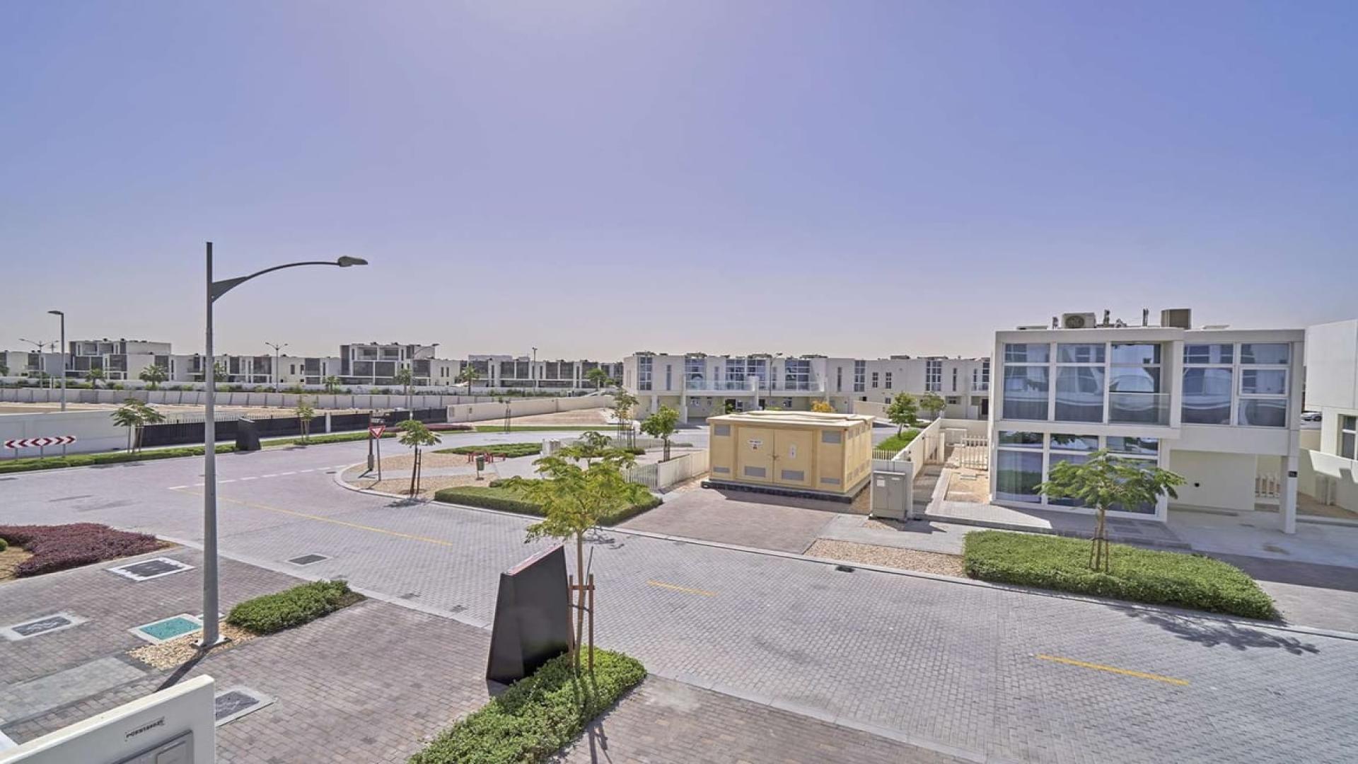 Modern furnished townhouse exterior in Damac Hills 2, available for rent with garden access