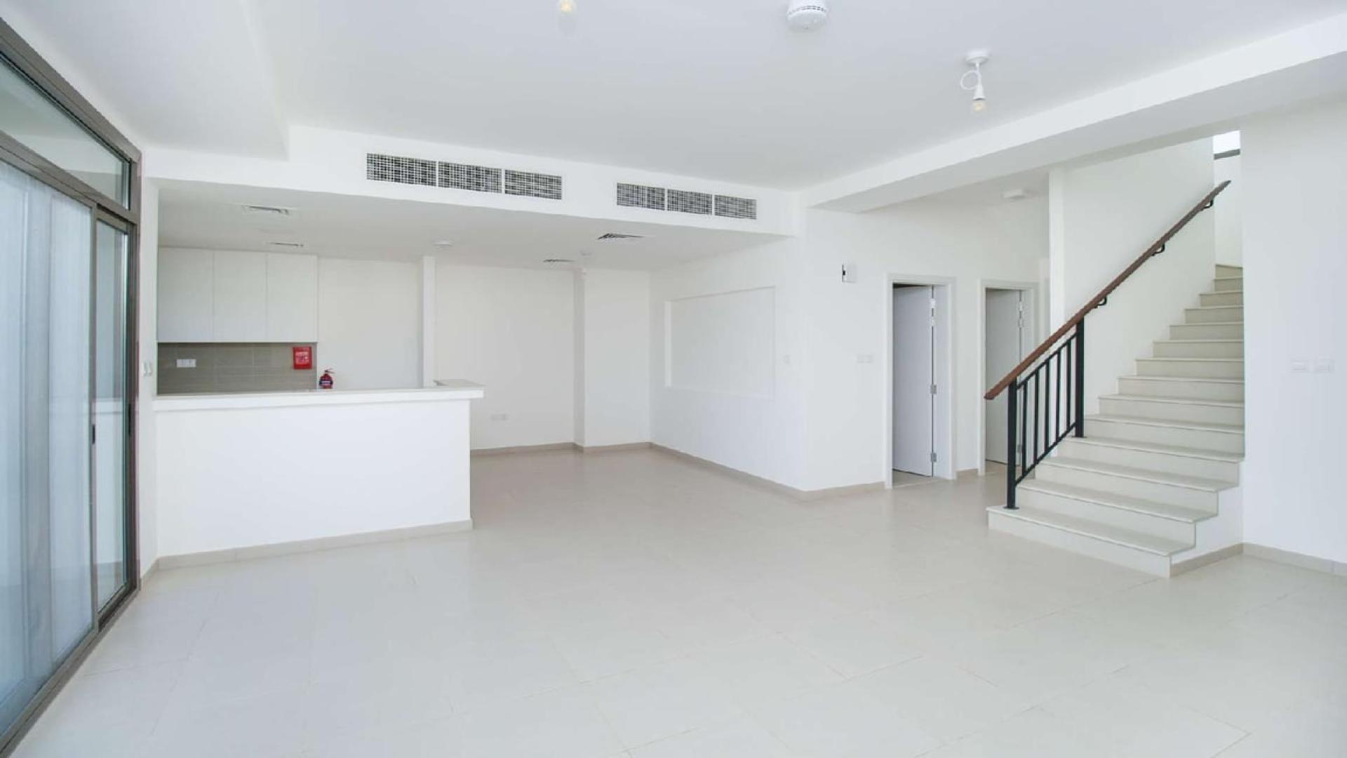 Modern open-plan kitchen and living area in Noor Townhouse, Town Square for rent