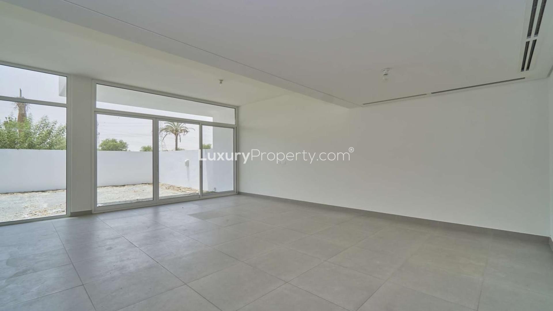 Spacious living room in Arabella 3 Mudon townhouse with large windows and garden view