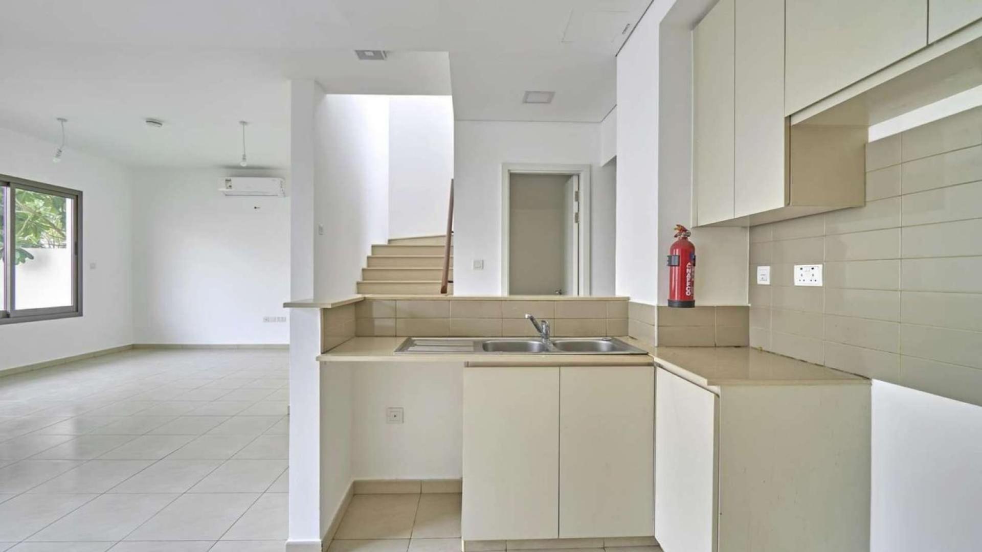 Modern kitchen and living area in three-bedroom townhouse, Hayat Townhouses, Town Square, Dubai