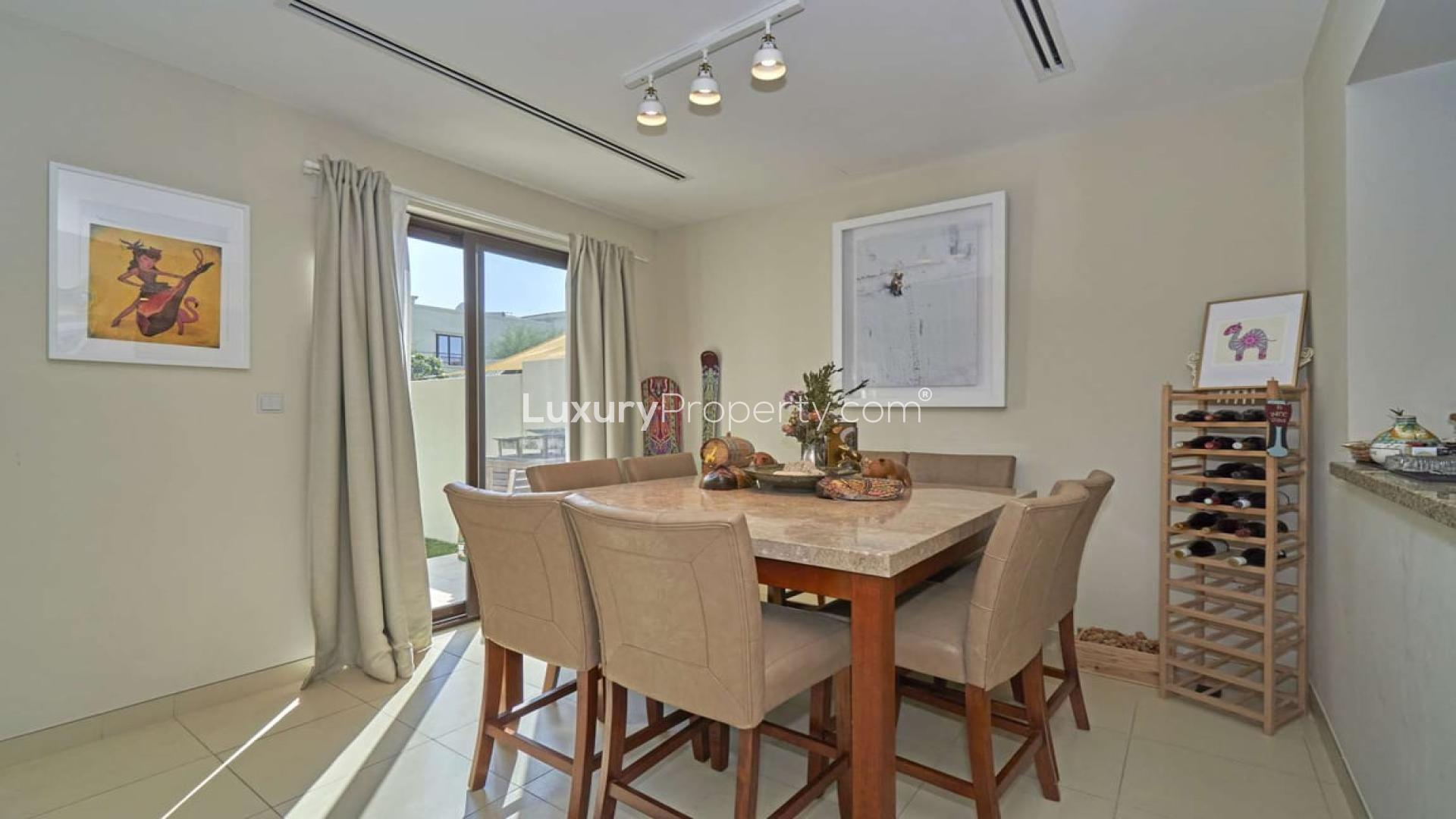 Modern living room in Mira townhouse, featuring cozy seating and garden view