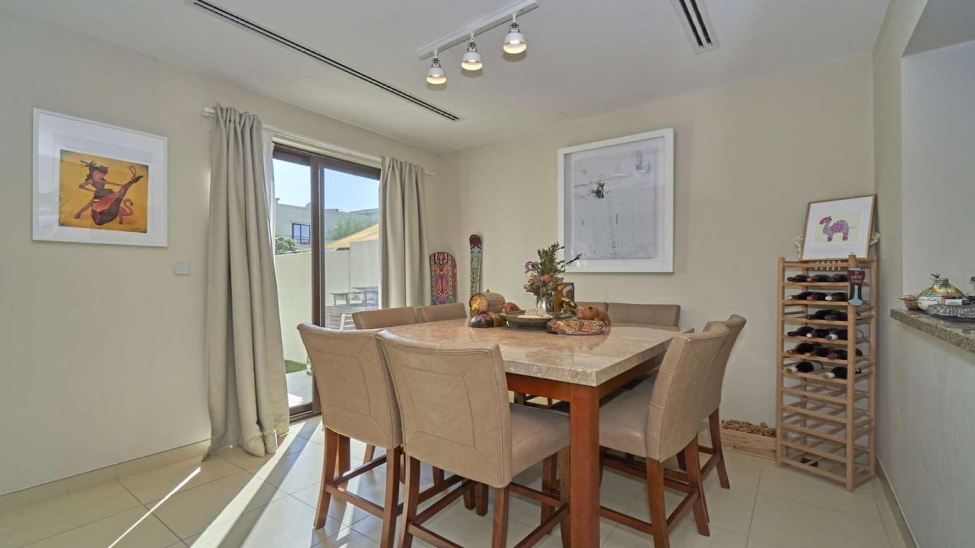 Modern living room in Mira townhouse, featuring cozy seating and garden view