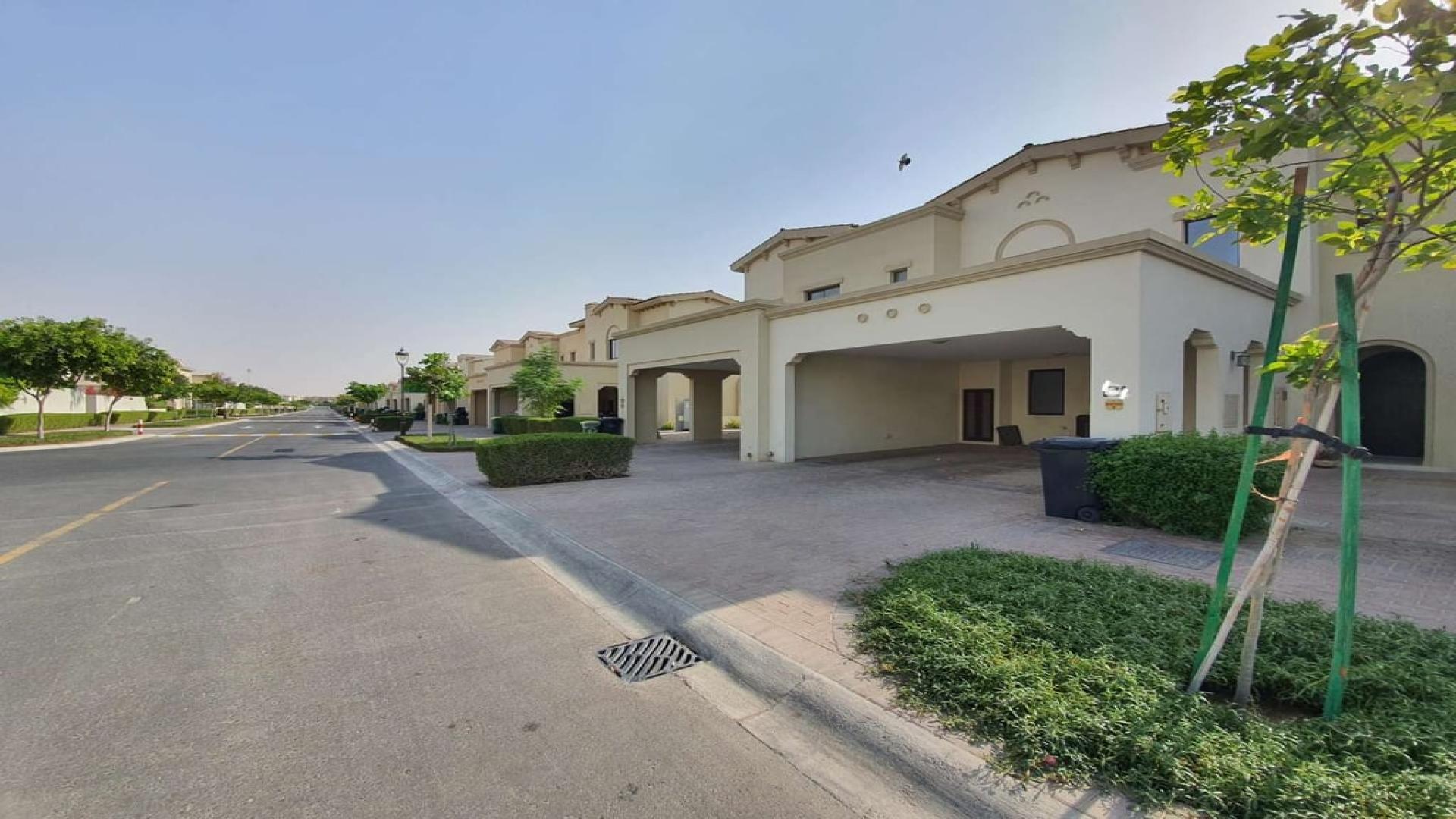 Spacious 3-bedroom townhouse exterior with landscaped garden in Mira, Reem community