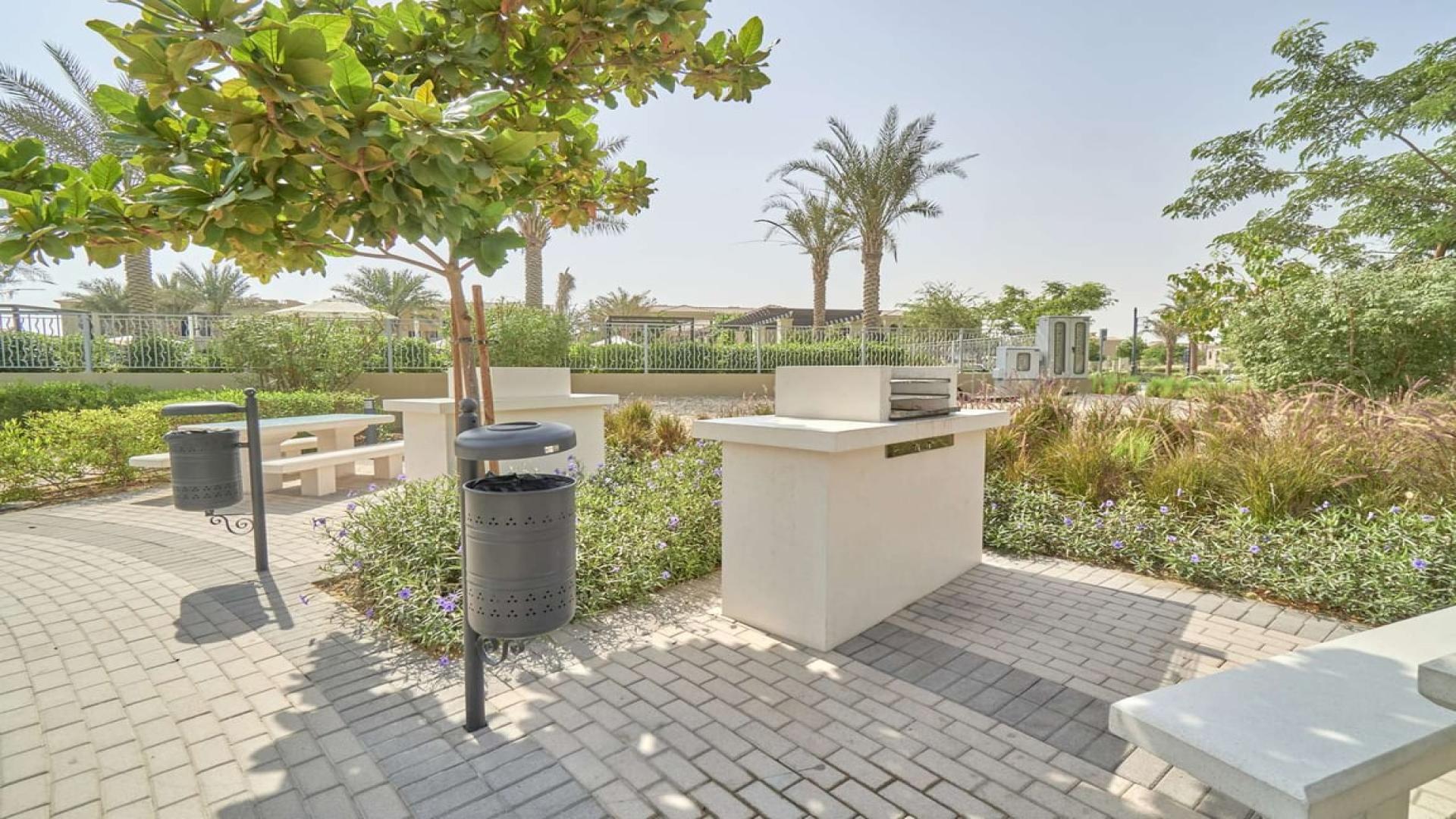 Playground in Casa Viva, Serena, Dubai townhouse community with shaded play area and slide