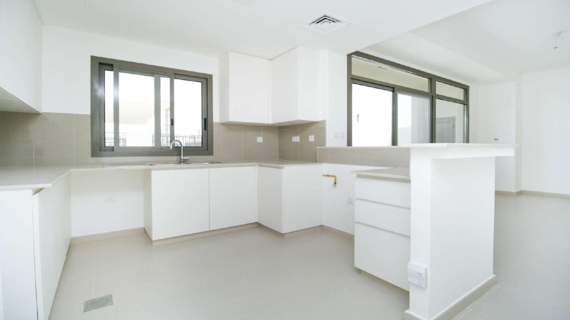 Bright living area with staircase in three-bedroom townhouse, Noor Townhouses, Town Square