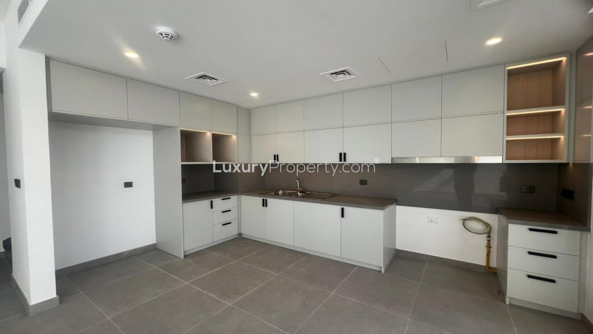 Modern kitchen and living area in Ruba townhouse, Arabian Ranches III, for rent