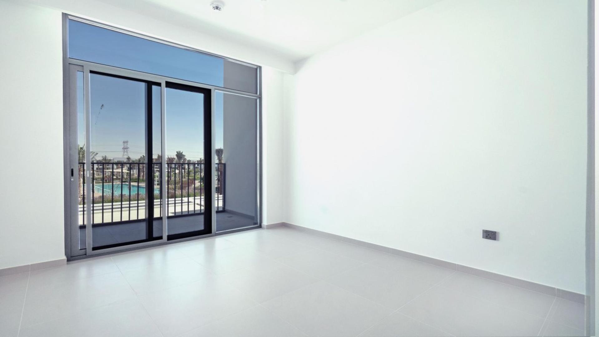 "Bright living area with large windows in Arabian Ranches III townhouse for rent.","Bright room with pool view in Arabian Ranches III townhouse for rent.",Spacious interior of three-bedroom townhouse in Joy, Arabian Ranches III, available for rent