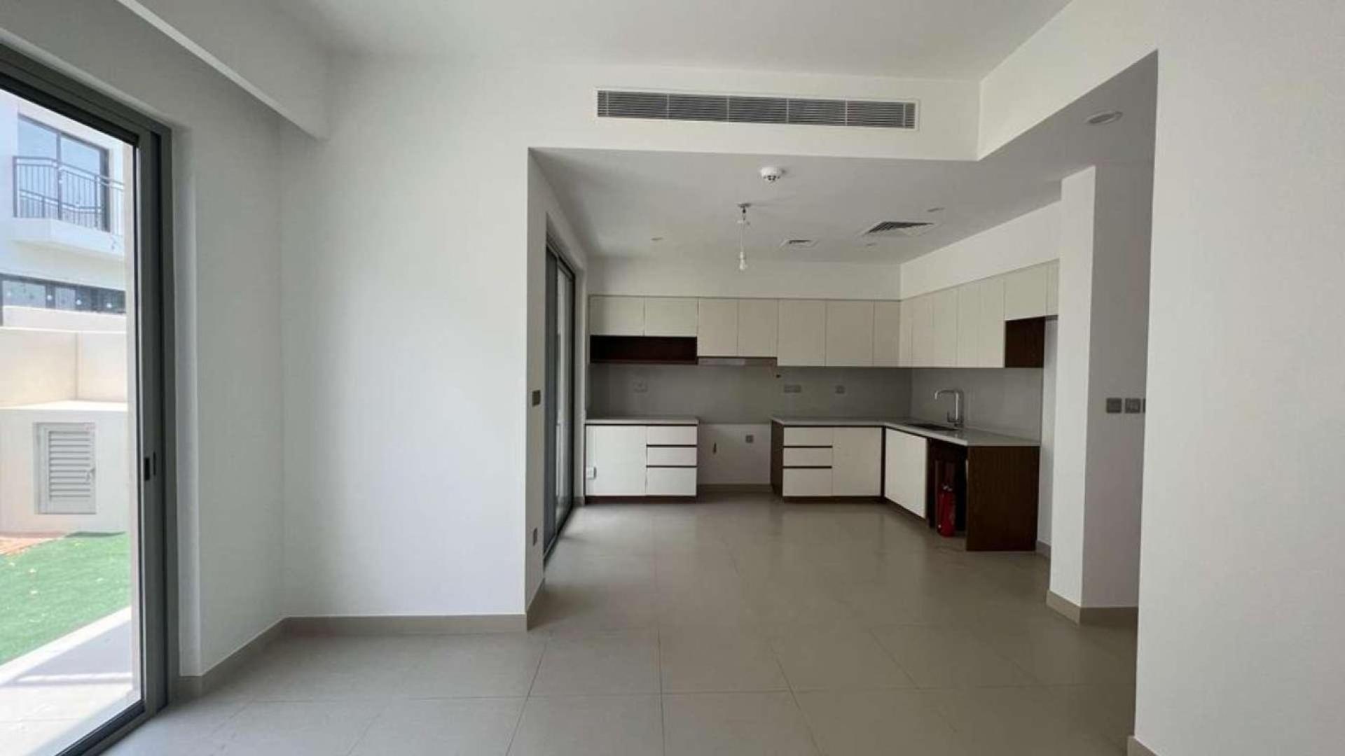 "Modern kitchen in vacant 3-bedroom townhouse, Camelia, Arabian Ranches 2, overlooking pool area.","Spacious modern kitchen in 3-bedroom Camelia townhouse, Arabian Ranches 2, available for rent.",Empty bedroom with built-in wardrobe in Camelia townhouse, Arabian Ranches 2, for rent