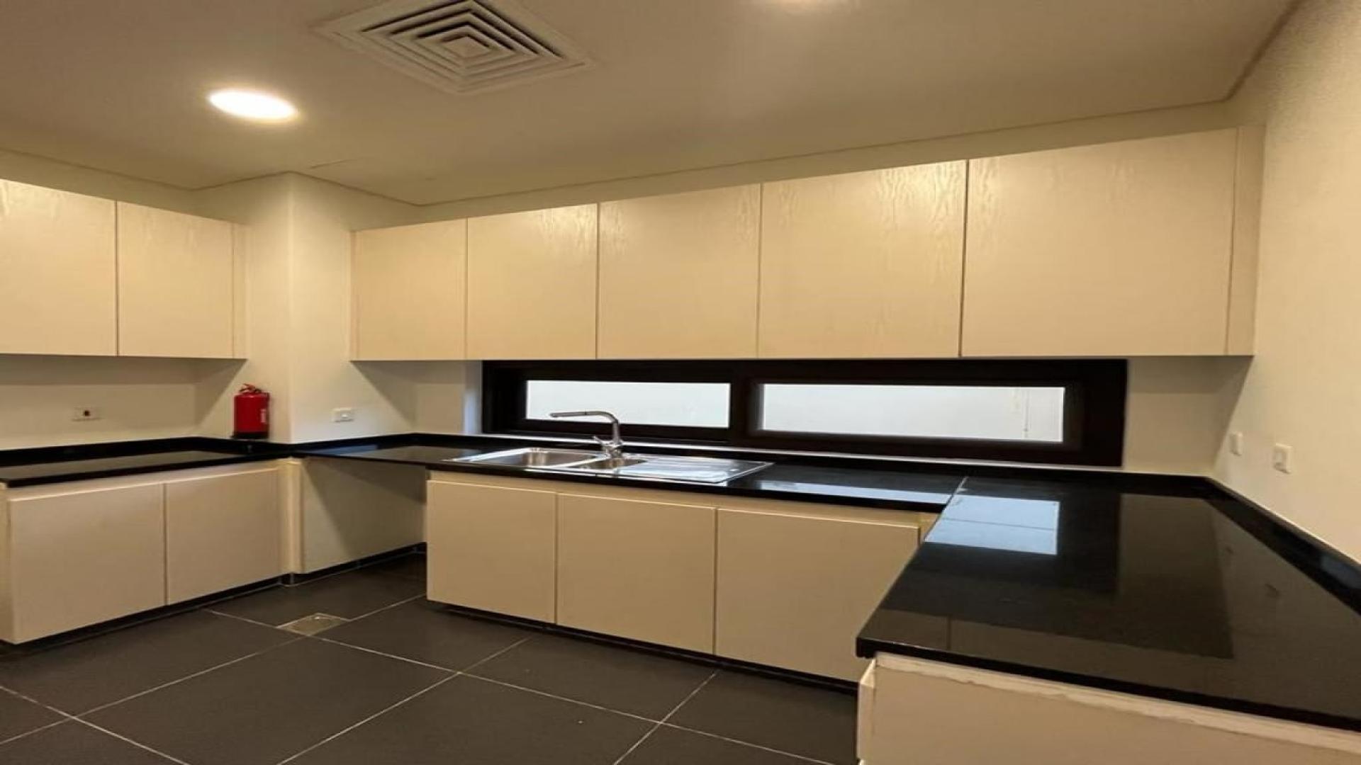 Luxurious Rochester townhouse interior with large windows in Damac Hills, available for rent