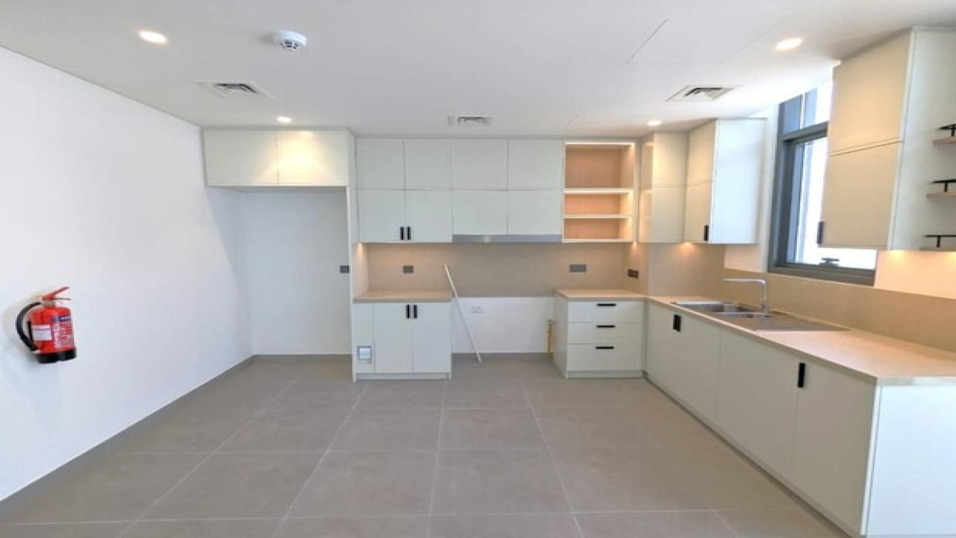 Modern kitchen and living area in Arabian Ranches 3 townhouse for rent, Ruba community