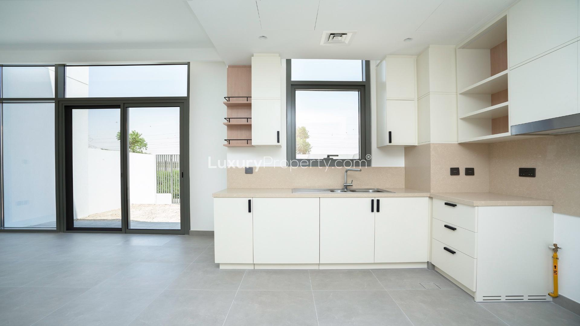 Modern townhouse exterior in Arabian Ranches 3, Ruba community, featuring spacious carport area