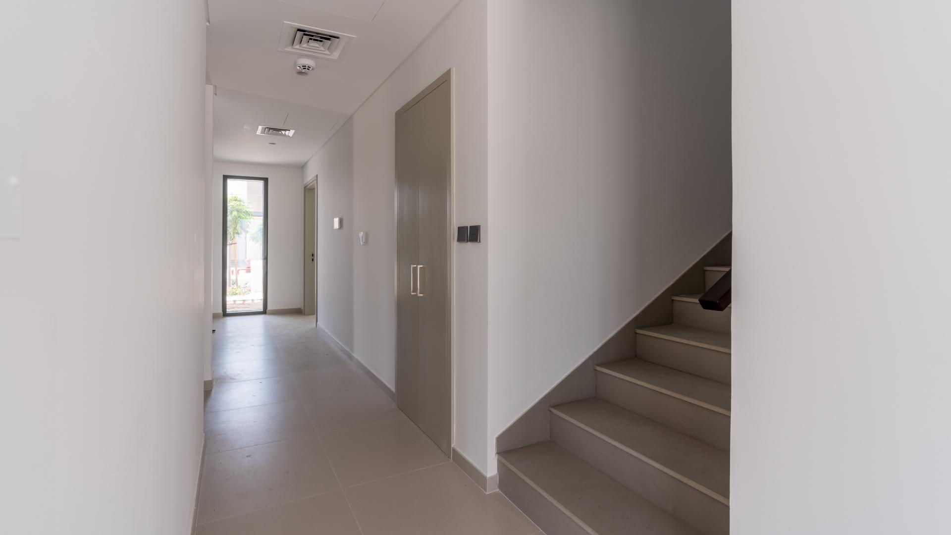 Modern living room in Ruba townhouse, Arabian Ranches 3, with large windows and tiled floors