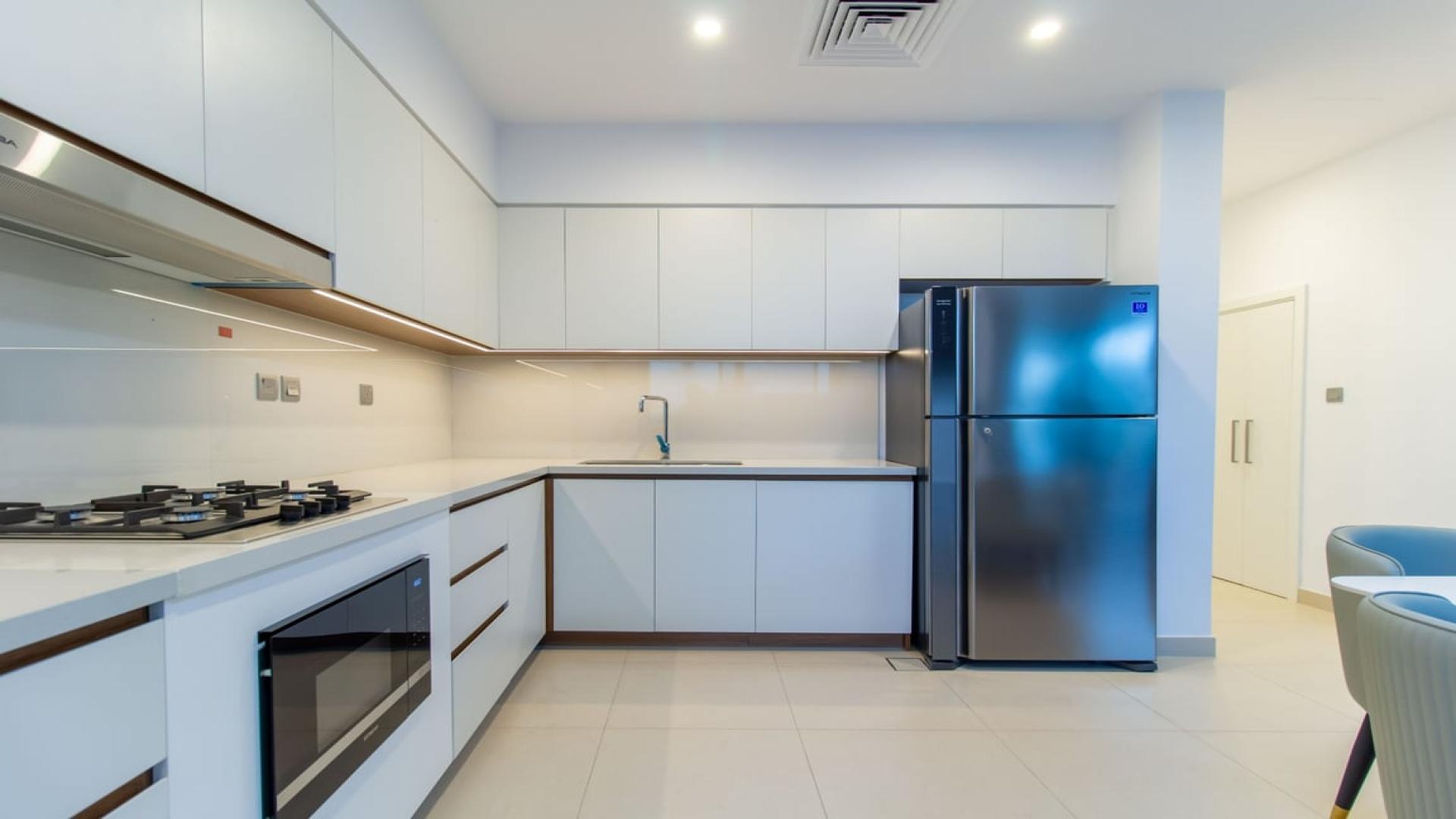 Modern kitchen in Camelia townhouse, Arabian Ranches 2, with sleek cabinetry and appliances
