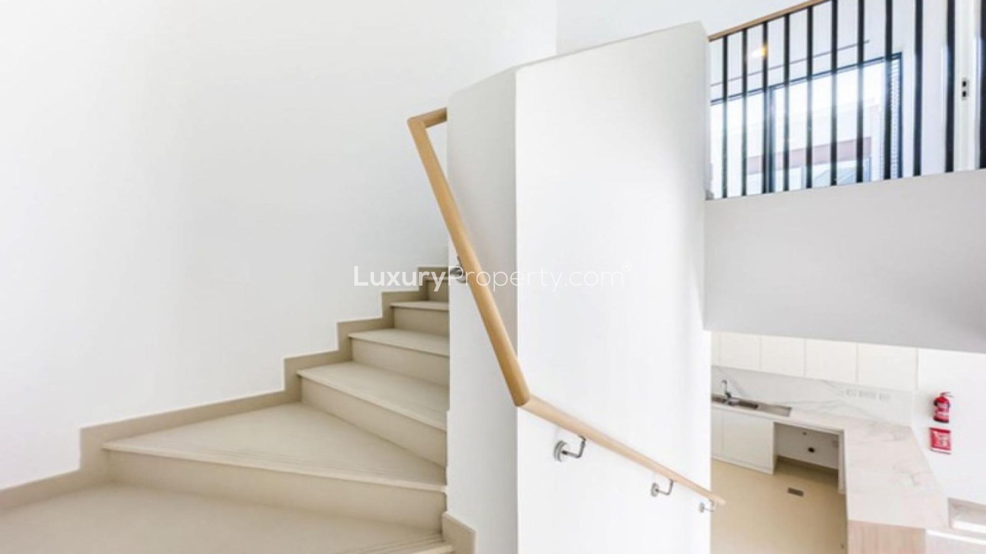 Brand new modern villa interior with open kitchen and staircase in Cherrywoods, Dubai Land