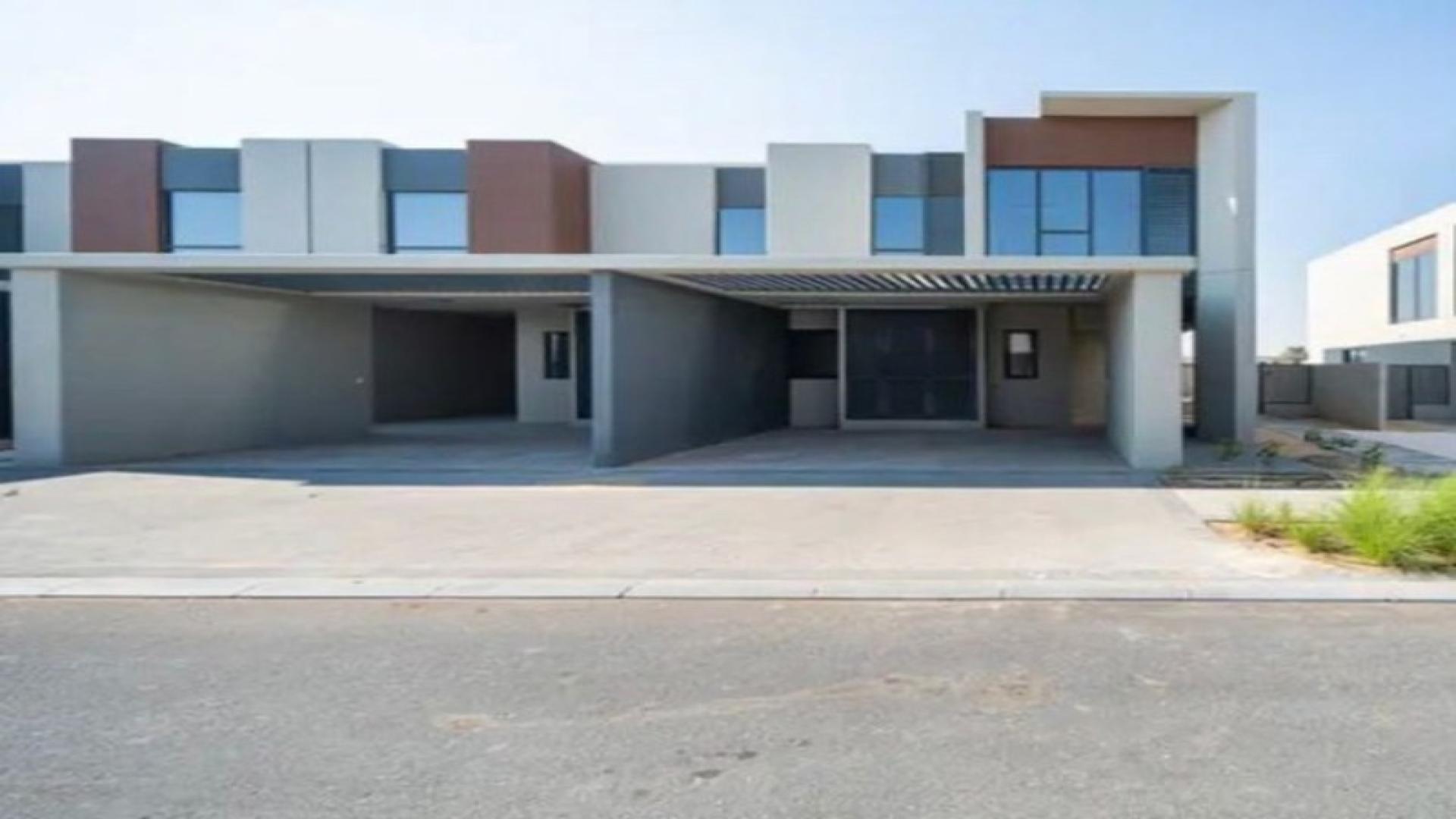 Outdoor pool area at Cherrywoods townhouse community, Dubai Land, with sun loungers and umbrellas