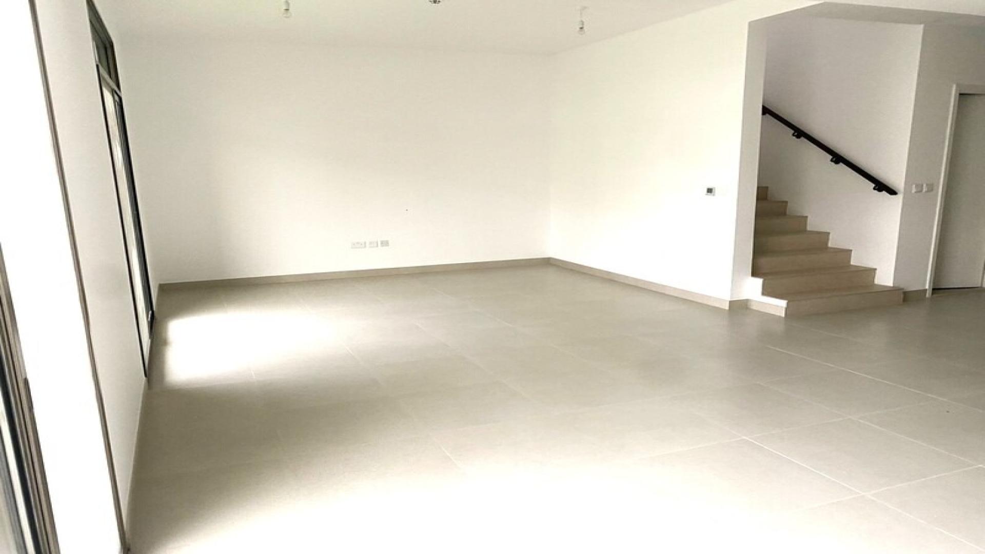 Spacious townhouse exterior with carport in Reem Townhouses, Town Square for rent