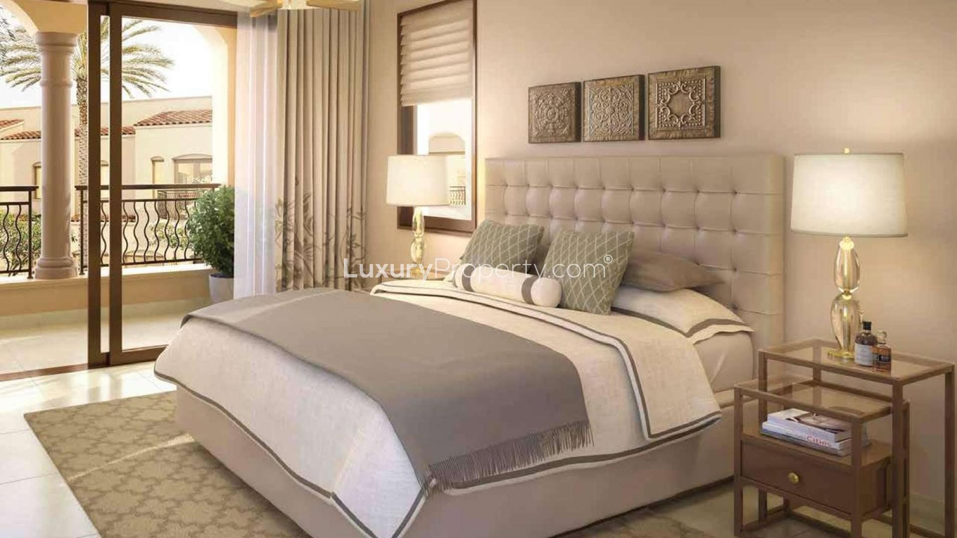 Charming Mediterranean-style townhouse exterior in Bella Casa, Serena, Dubailand, with lush garden