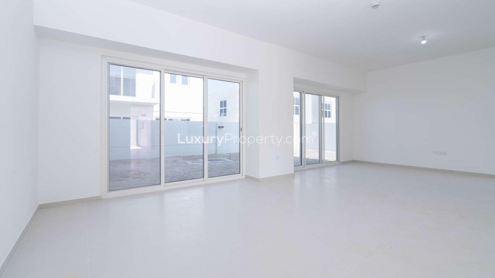 Spacious living room in Arabella 3 villa, Mudon with large windows and natural light