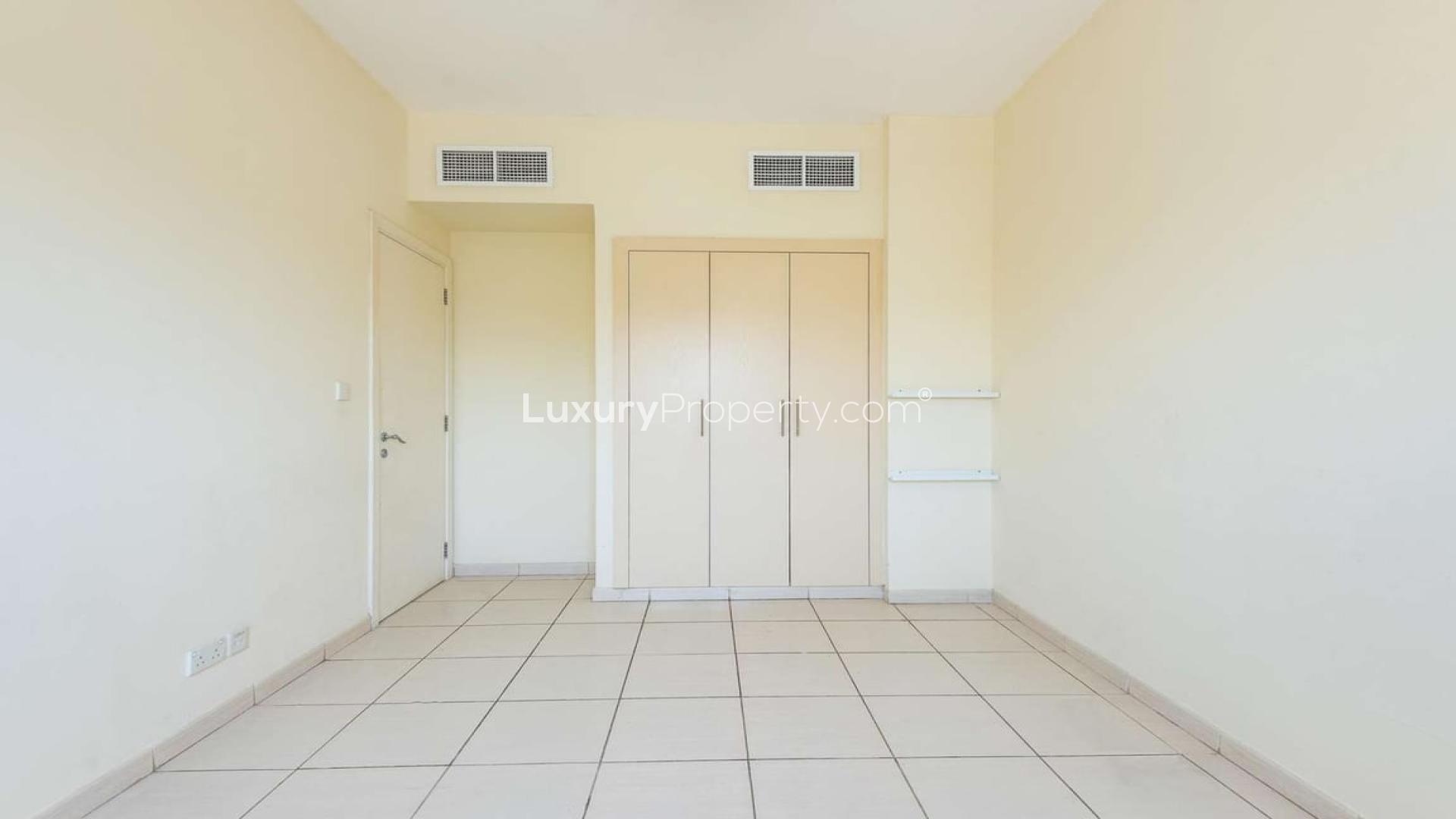 "Vastu compliant townhouse view, overlooking lush park and pool in The Springs.",Empty room with tiled floor and built-in wardrobe in The Springs townhouse for sale