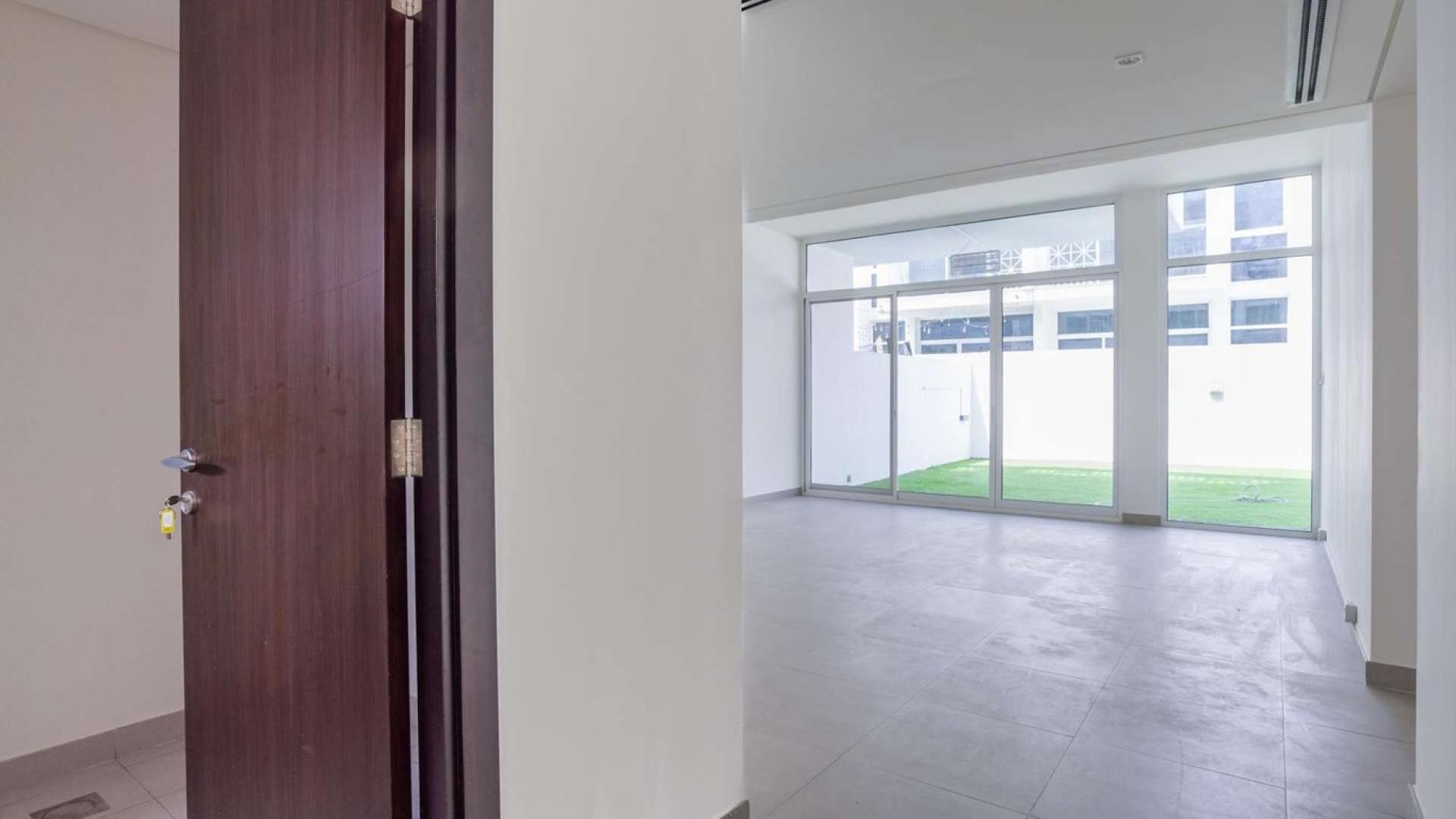 Modern 3-bedroom townhouse exterior in quiet Arabella Townhouses, Mudon community, available for sale