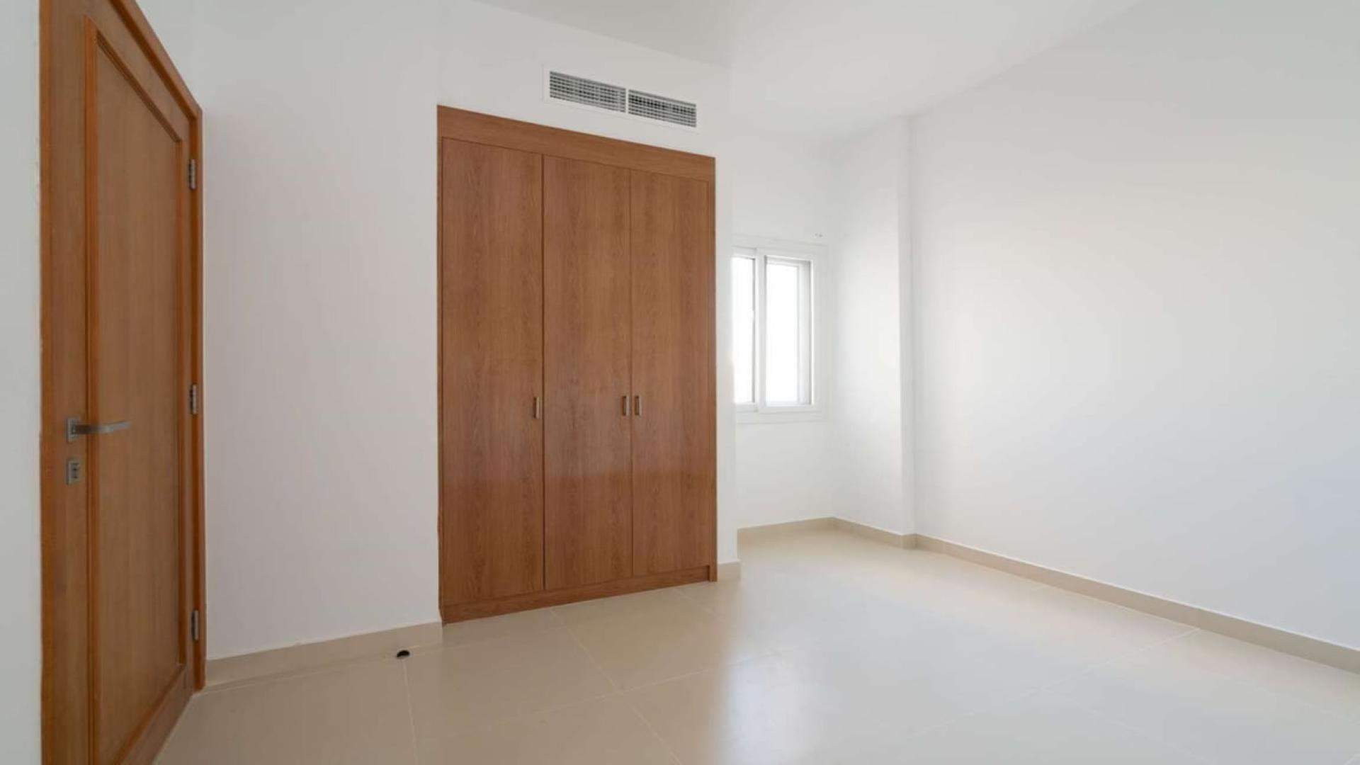 Elegant three-bedroom villa exterior in Casa Viva, Serena, featuring modern architecture and lush greenery