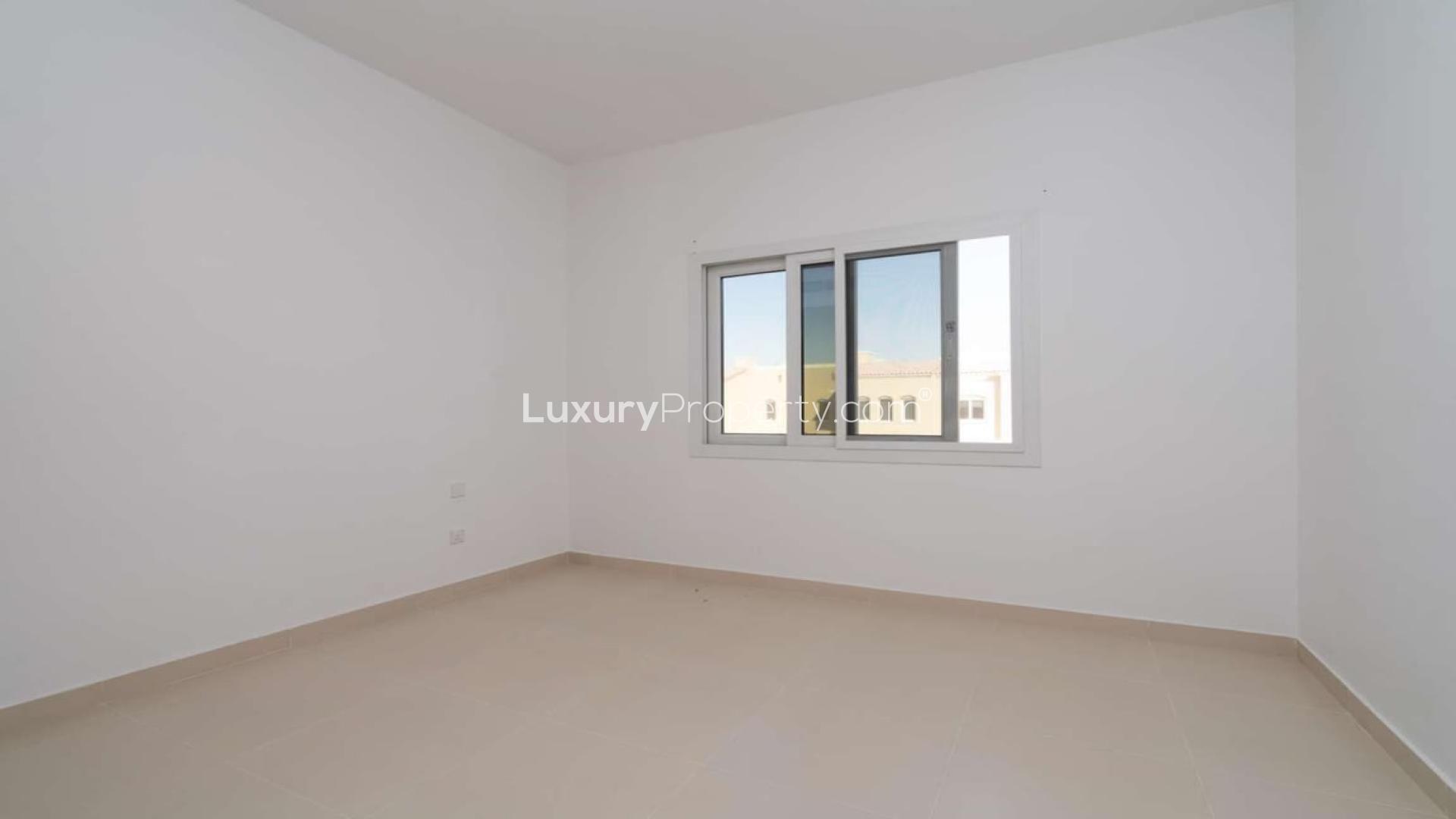 Elegant three-bedroom townhouse exterior in Casa Viva, Serena community, for sale