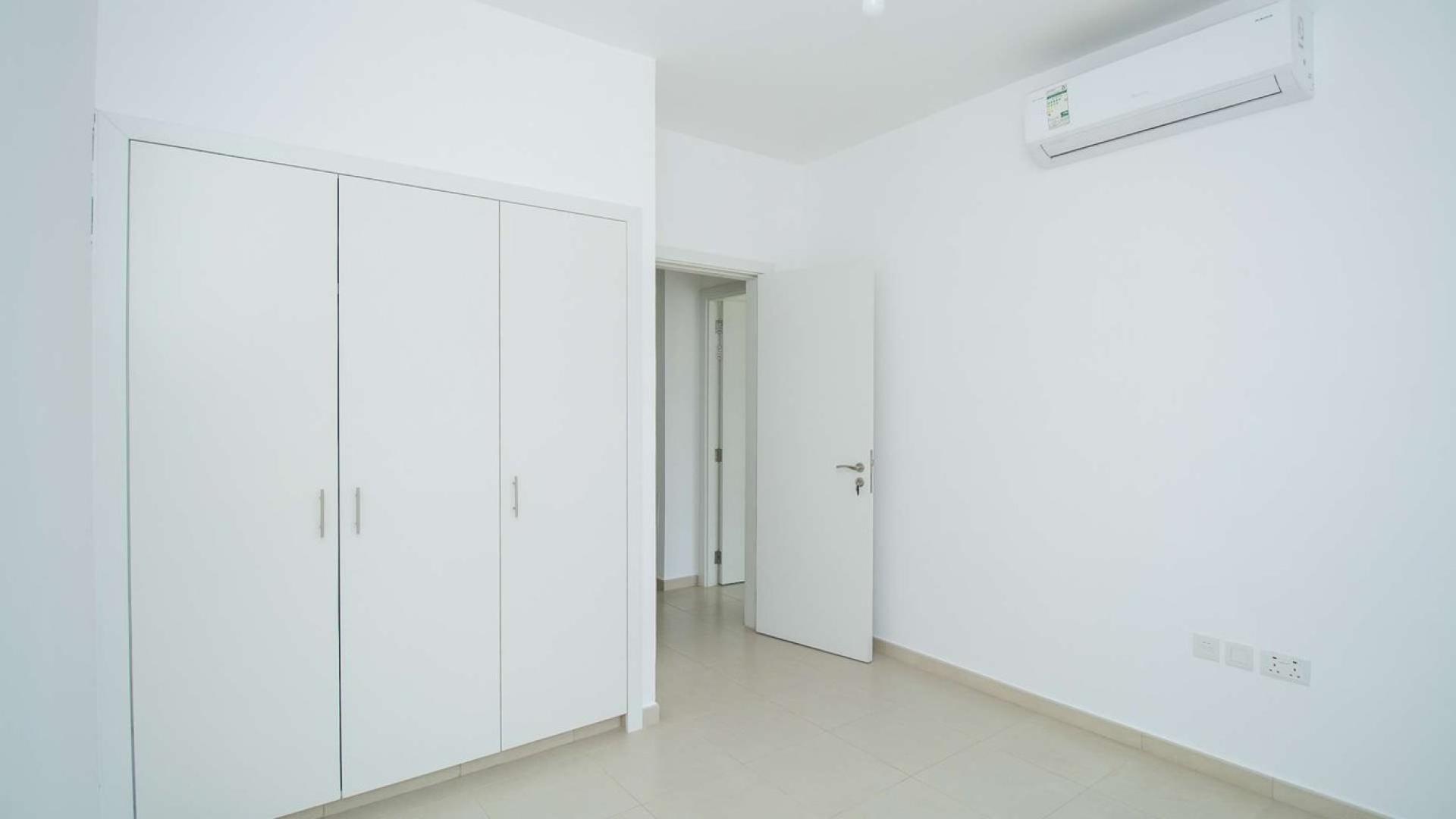 3-bedroom townhouse exterior in Hayat, Town Square with carport and modern design