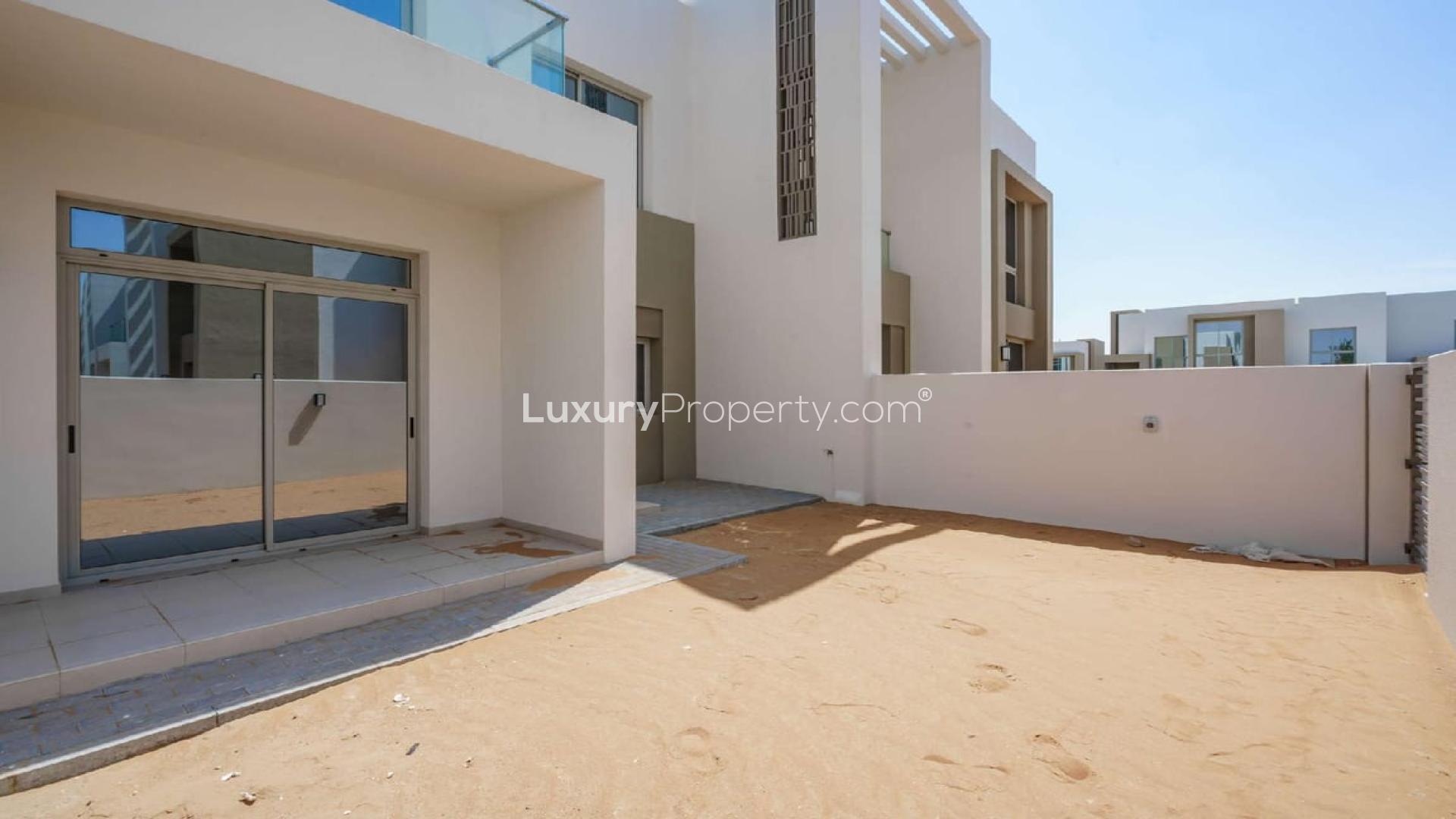 Modern open-plan kitchen and living area in Arabian Ranches 2 townhouse for sale