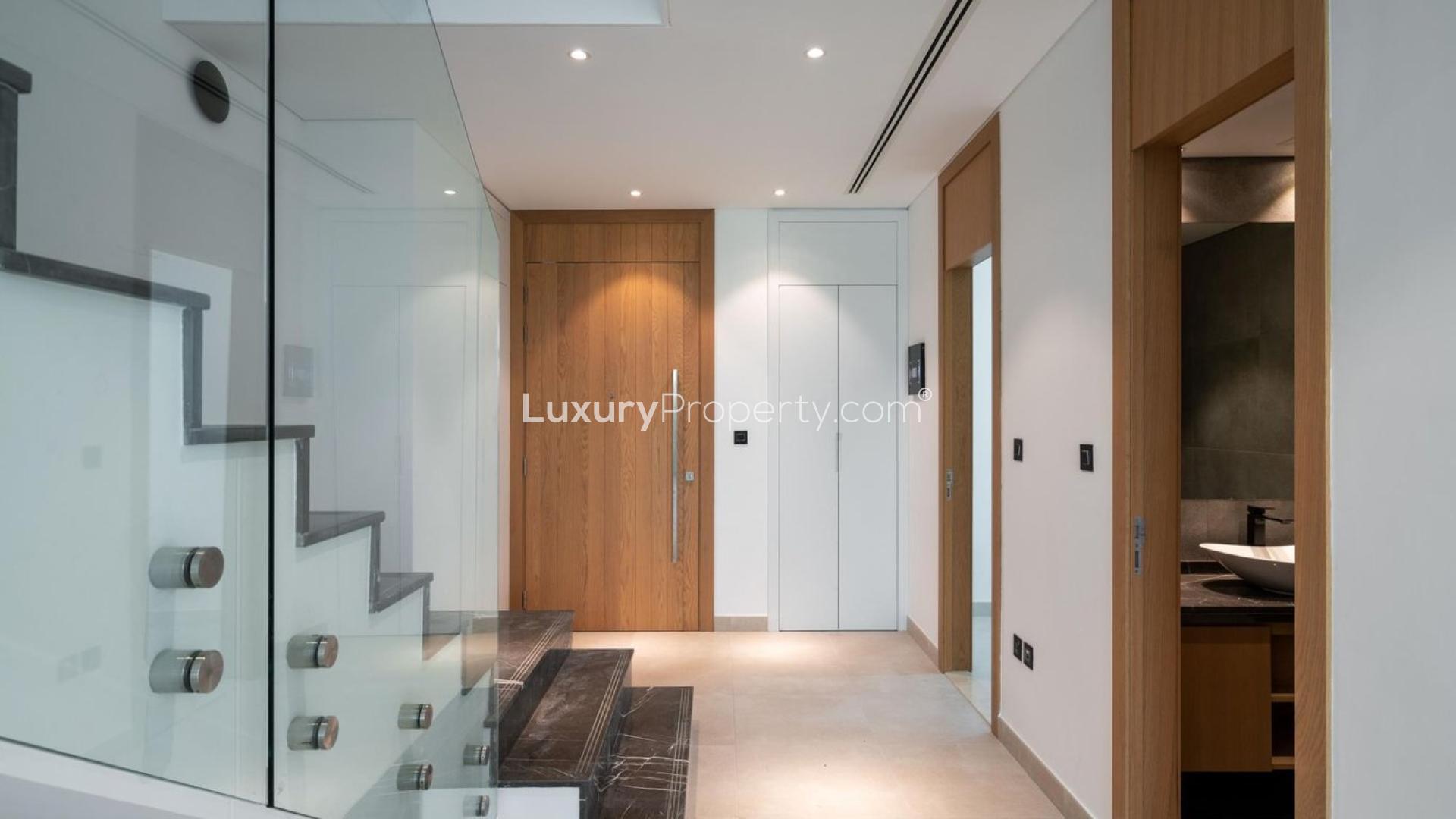 Modern townhouse interior with glass staircase in Jumeirah Golf Estates, Jumeirah Luxury community