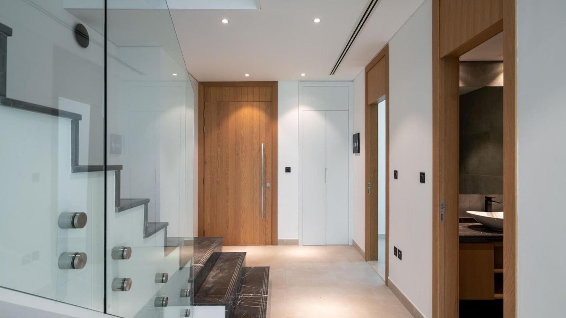 Modern townhouse interior with glass staircase in Jumeirah Golf Estates, Jumeirah Luxury community