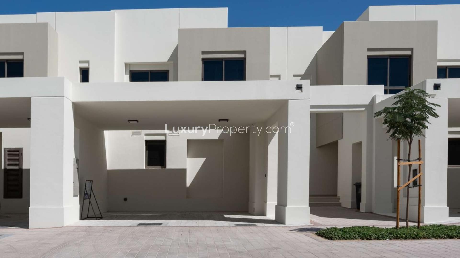 Modern 3-bedroom townhouse exterior in Noor Townhouses, Town Square, for sale
